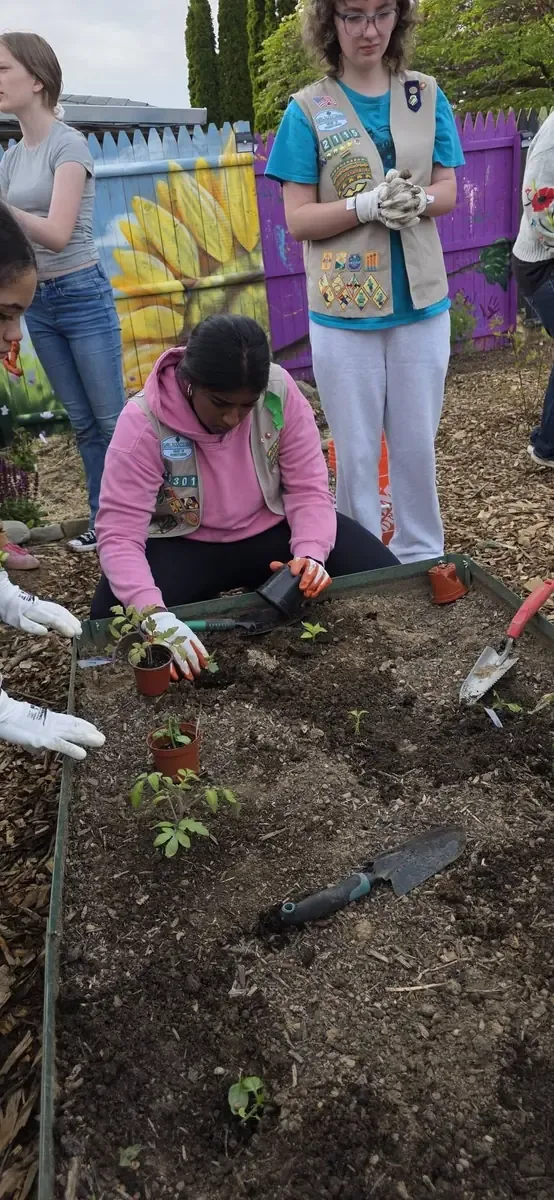 Children participating in hands on garden learning